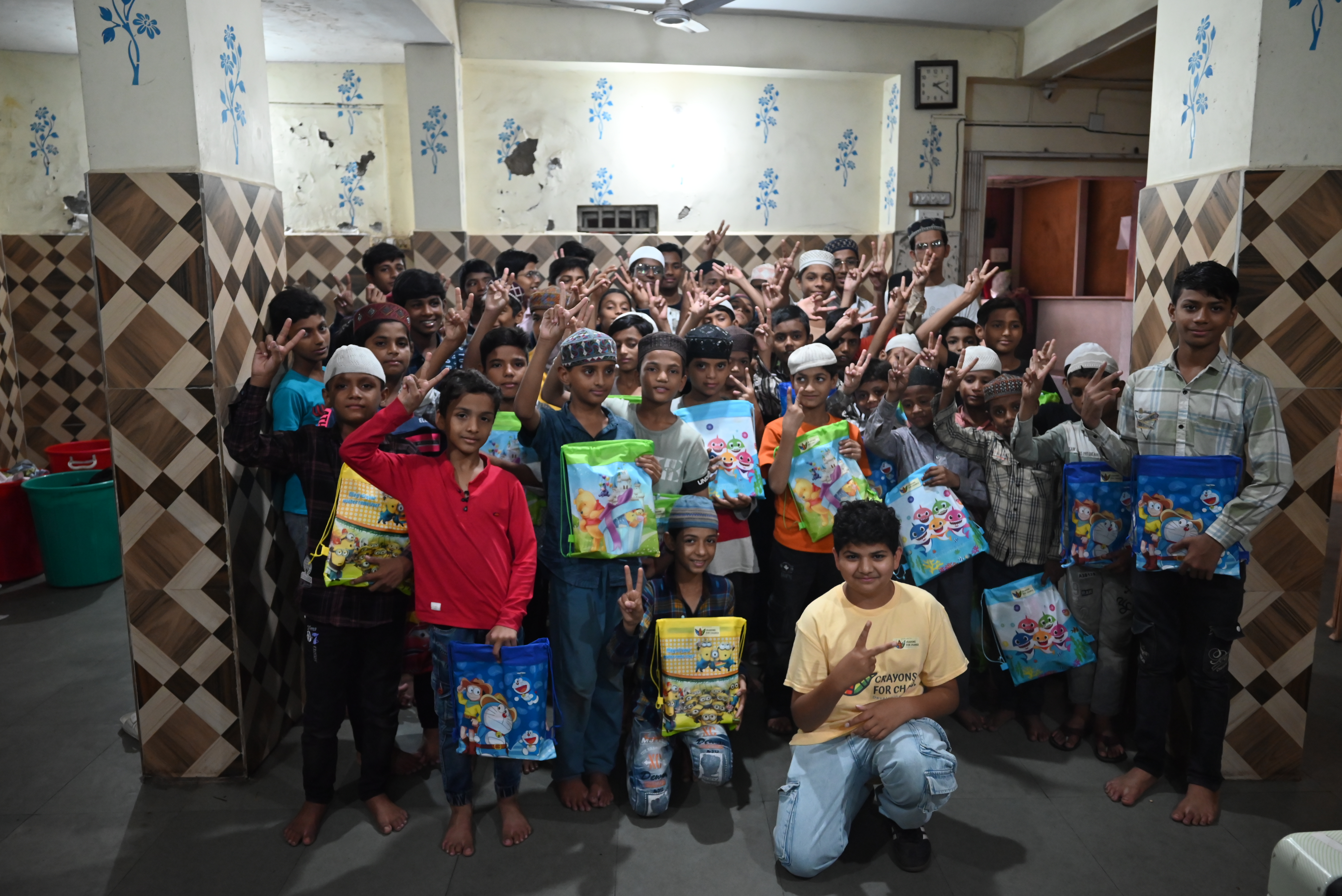 Students with school supplies at a Crayons for Change event