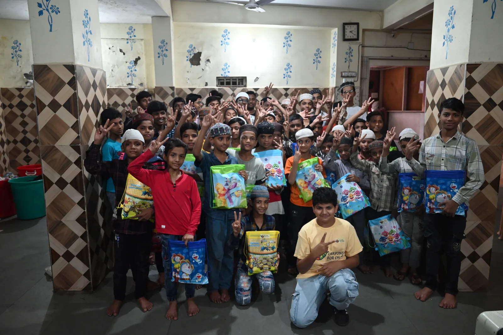 Students holding school supply bags during the Ahmedabad Project in India.
